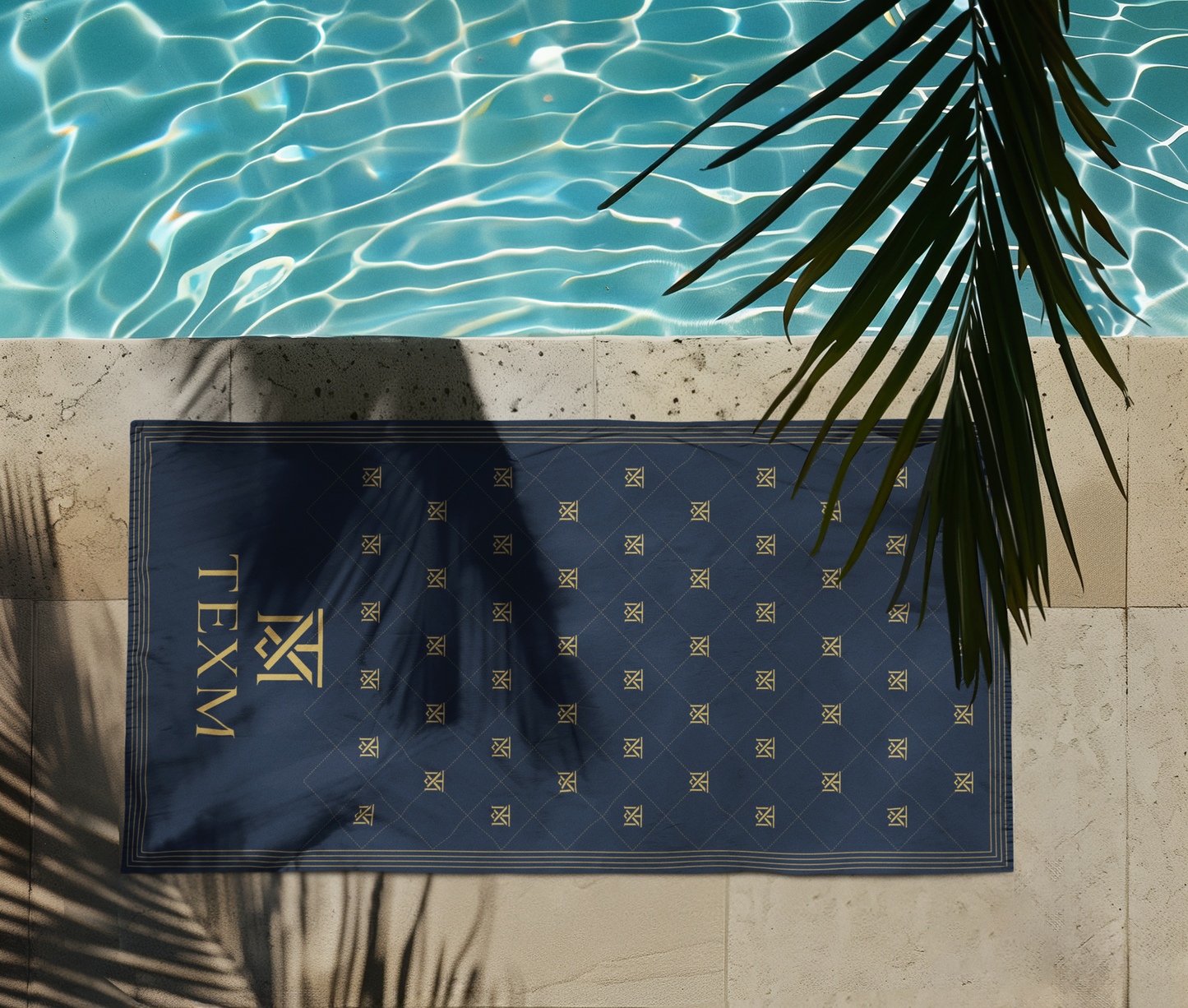 TEXM Heritage Navy & Gold beach towel laid on warm sand by the shore