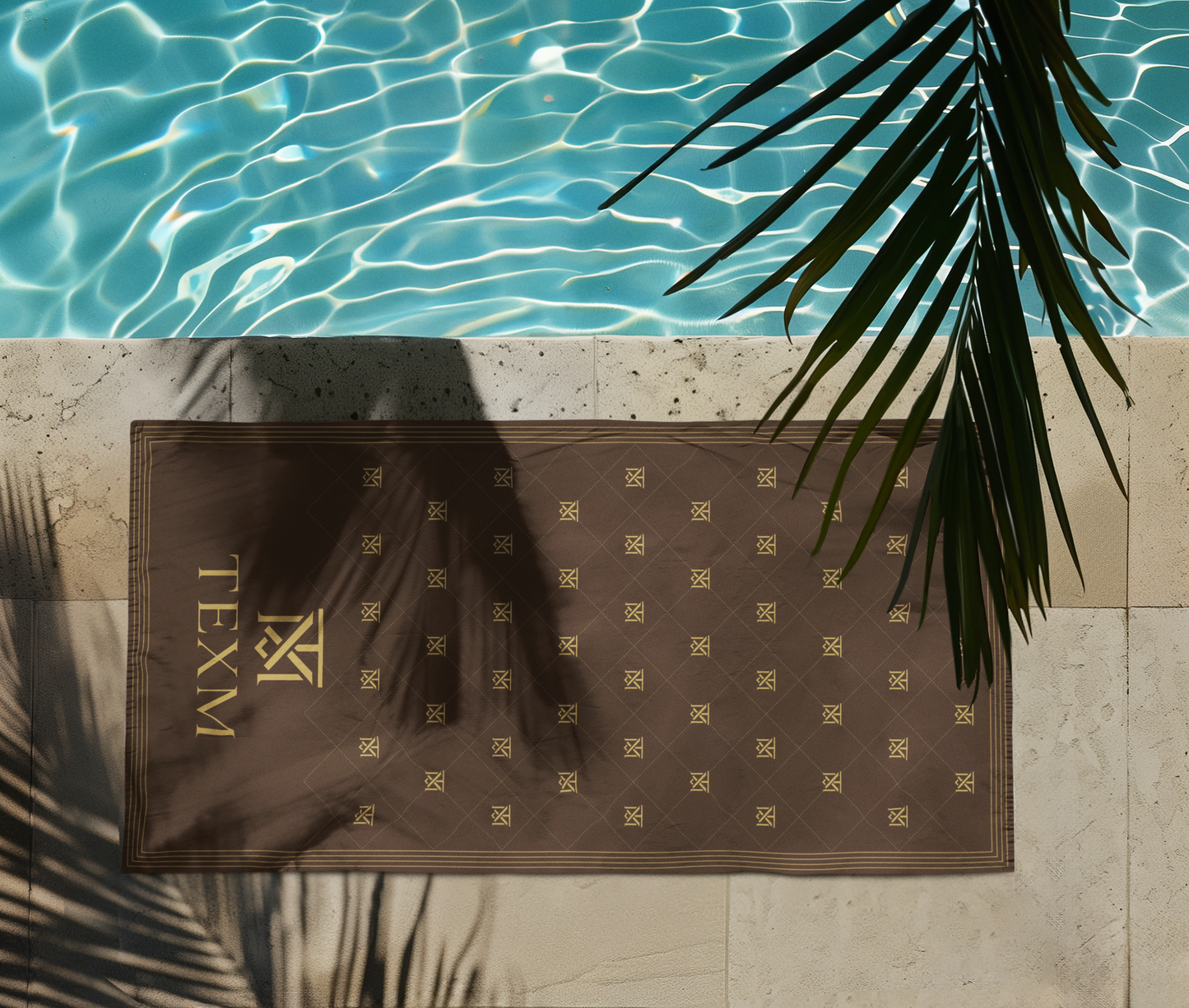 TEXM Heritage Chocolate & Gold beach towel laid on warm sand by the shore